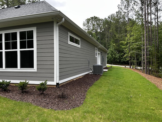 217 Holly Ln, Mccormick, SC 29835 - view of side of property featuring cooling unit, a lawn, and roof with shingles