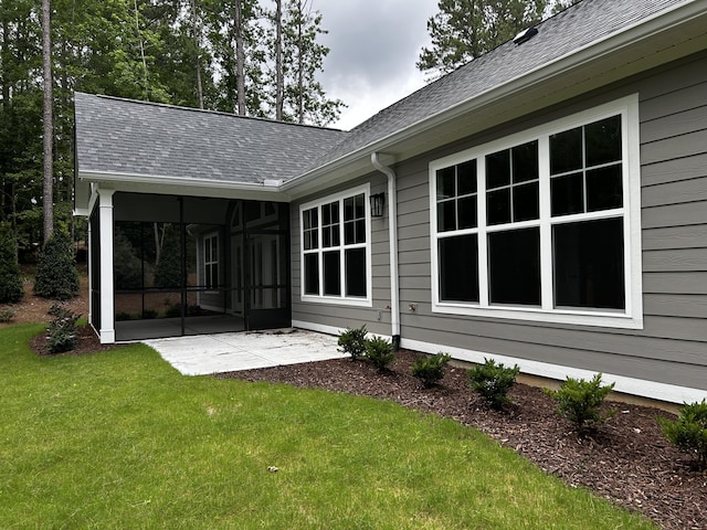 217 Holly Ln, Mccormick, SC 29835 - back of house with a sunroom, a patio area, a yard, and a shingled roof