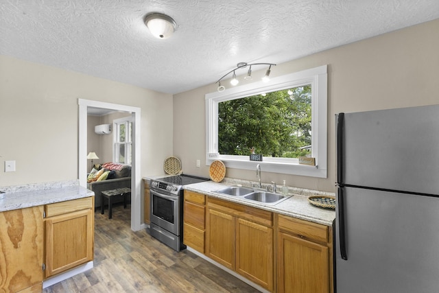 2028 Battle Row, Augusta, GA 30904 - kitchen featuring appliances with stainless steel finishes, a sink, wood finished floors, light countertops, and a textured ceiling