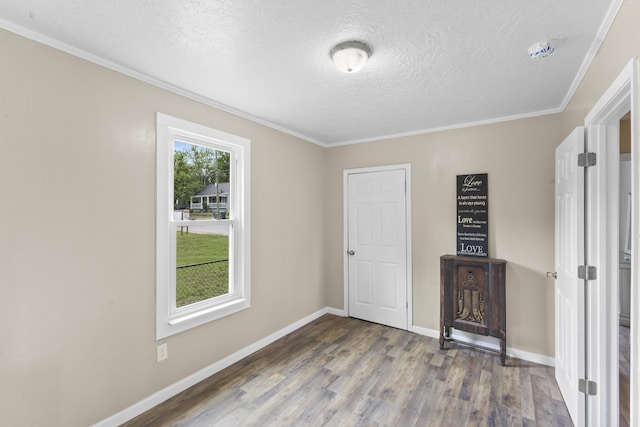 2028 Battle Row, Augusta, GA 30904 - unfurnished bedroom featuring wood finished floors, a textured ceiling, baseboards, and crown molding