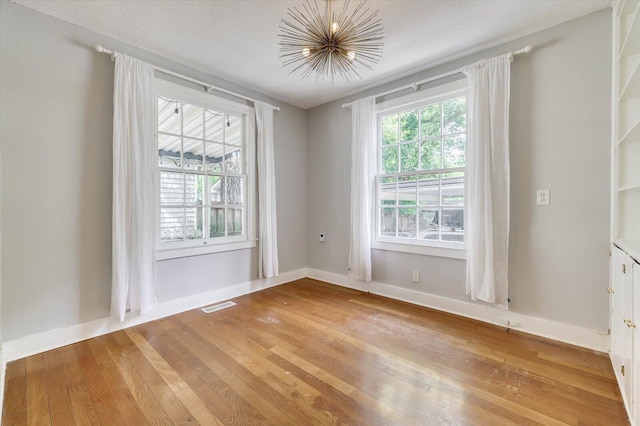 empty room with light hardwood / wood-style floors