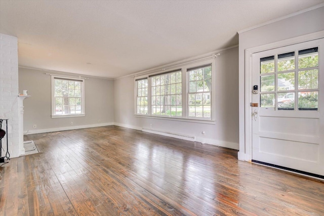 unfurnished living room featuring a brick fireplace, dark wood-type flooring, crown molding, and a baseboard radiator