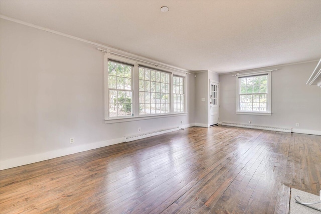 spare room with crown molding, a baseboard radiator, a textured ceiling, and hardwood / wood-style flooring