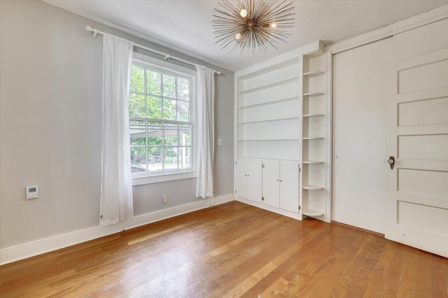 unfurnished bedroom with a textured ceiling and hardwood / wood-style flooring