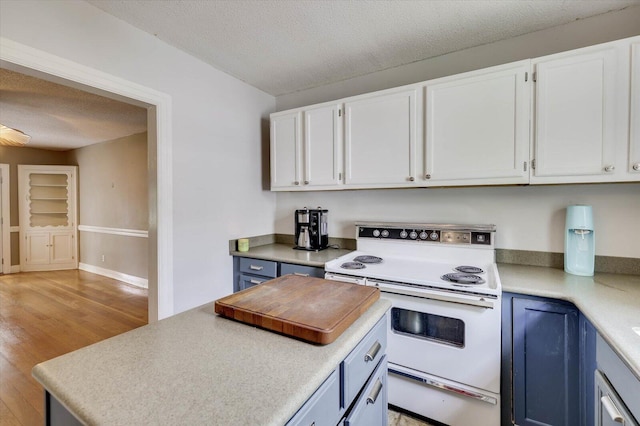 kitchen with white cabinets, blue cabinetry, white electric stove, and a textured ceiling