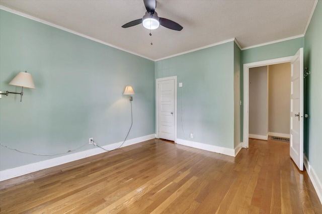 unfurnished bedroom with ceiling fan, hardwood / wood-style flooring, and ornamental molding