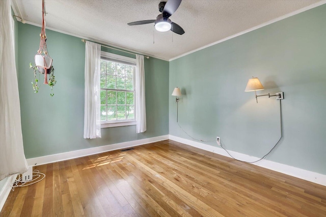 spare room featuring crown molding, ceiling fan, a textured ceiling, and hardwood / wood-style flooring