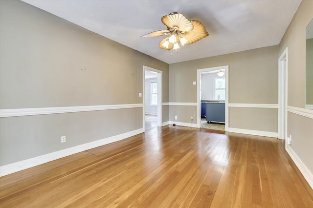 empty room with ceiling fan and hardwood / wood-style floors