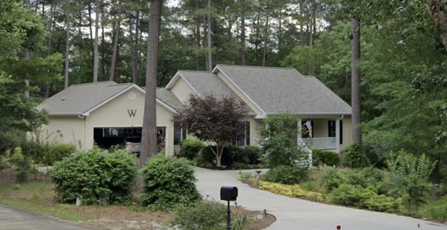 single story home featuring aphalt driveway and a garage