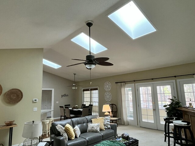 dining space featuring vaulted ceiling with skylight, wood finished floors, and ceiling fan