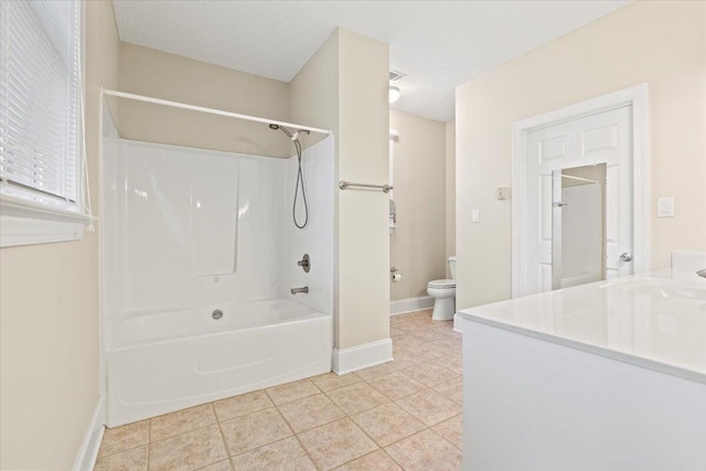 full bathroom with tile patterned floors, a textured ceiling, toilet, shower / washtub combination, and vanity