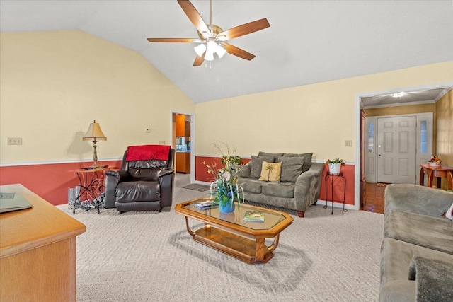 carpeted living room with vaulted ceiling and ceiling fan