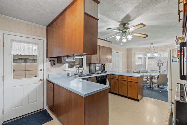 kitchen featuring crown molding, sink, ceiling fan, a textured ceiling, and kitchen peninsula