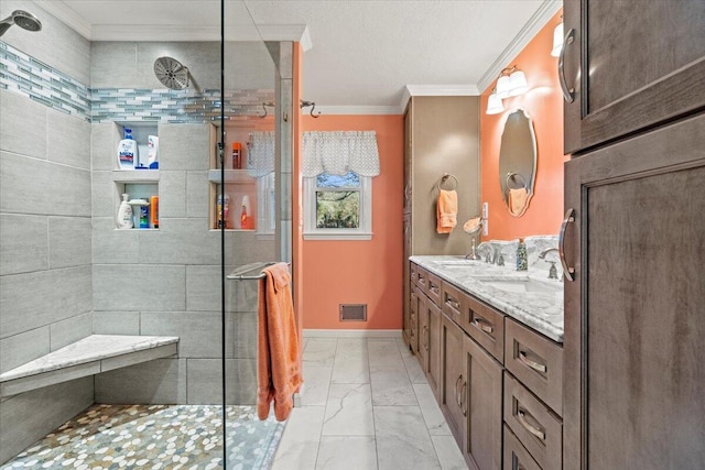 bathroom with tiled shower, vanity, and ornamental molding