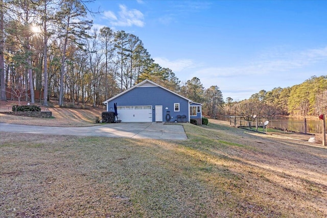 exterior space featuring a lawn and a garage