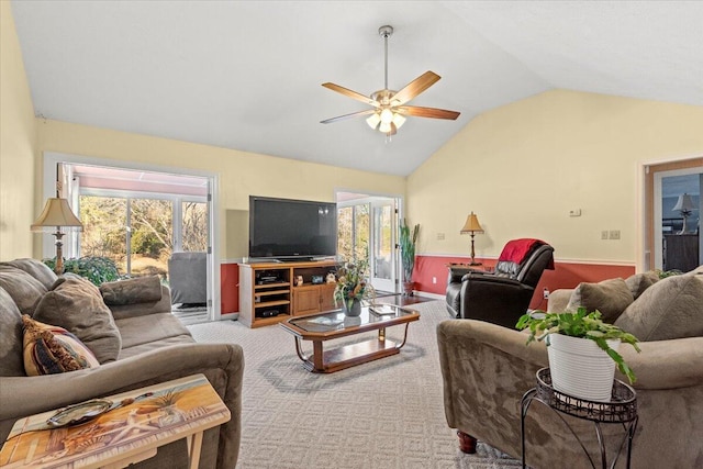 carpeted living room with ceiling fan, lofted ceiling, and a wealth of natural light