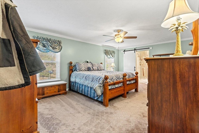 bedroom featuring crown molding, carpet flooring, ceiling fan, a barn door, and a textured ceiling