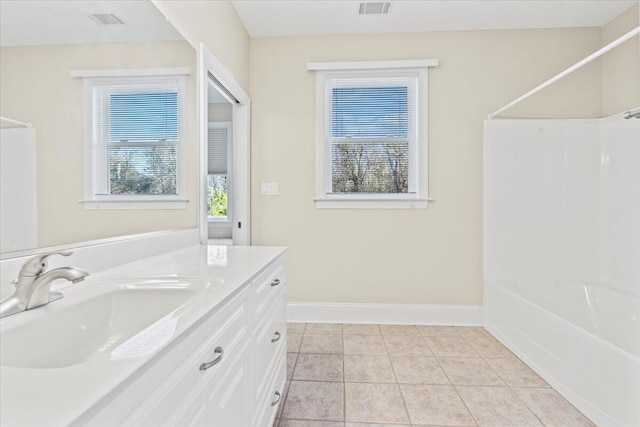 bathroom featuring tile patterned floors, shower / washtub combination, and vanity