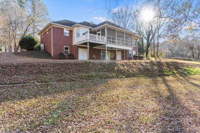 rear view of property featuring a sunroom