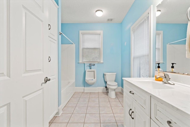 full bathroom featuring bathtub / shower combination, vanity, a textured ceiling, tile patterned flooring, and toilet