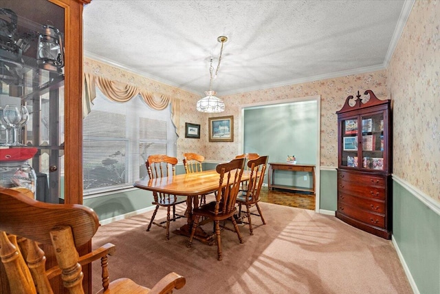 dining space featuring a textured ceiling, carpet floors, and crown molding