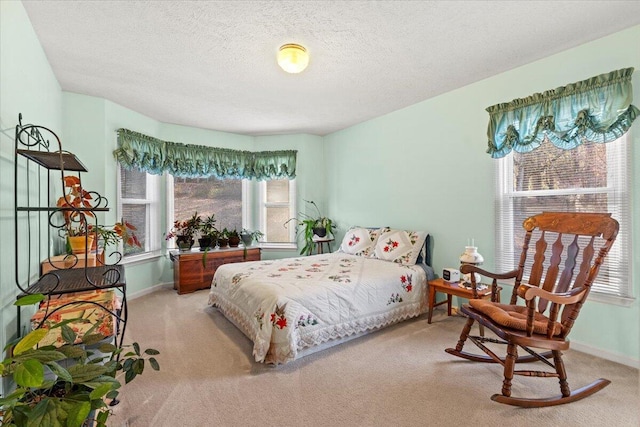 carpeted bedroom featuring a textured ceiling