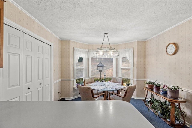 carpeted dining space with a textured ceiling and ornamental molding