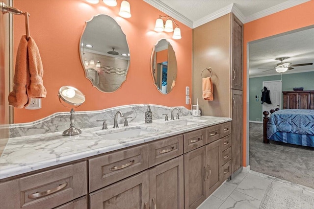 bathroom with vanity, ceiling fan, and crown molding