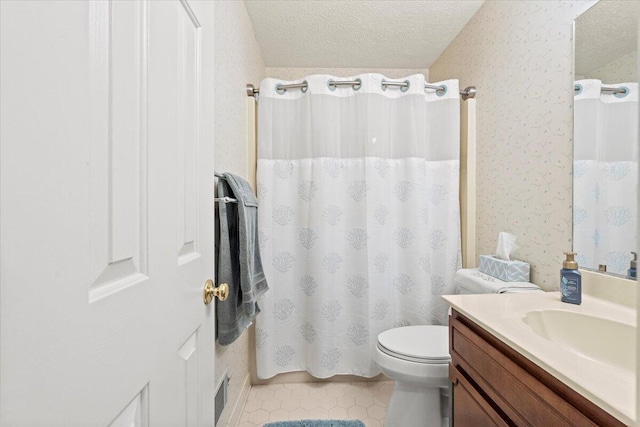 bathroom featuring vanity, tile patterned flooring, toilet, a textured ceiling, and walk in shower