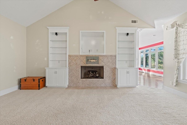 living room featuring a fireplace, light carpet, and vaulted ceiling