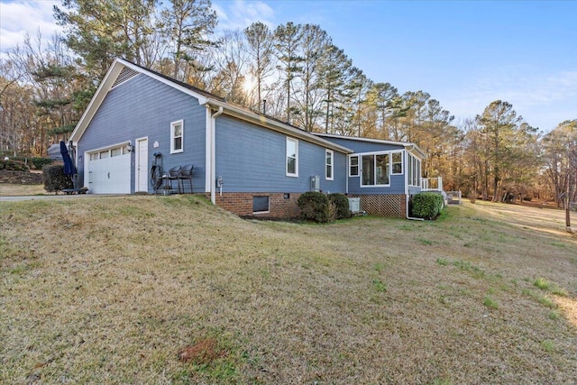 view of side of home with a lawn, a sunroom, and a garage