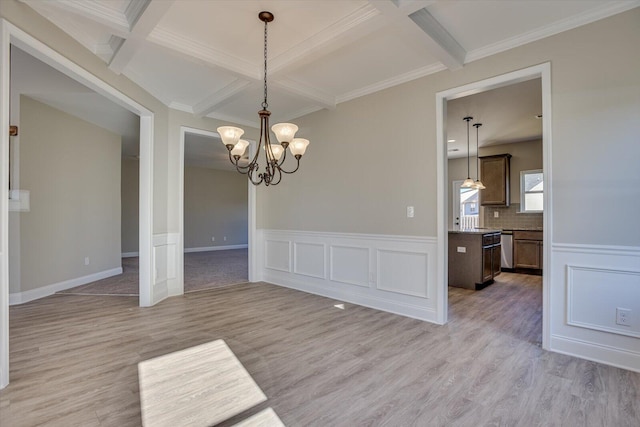 unfurnished dining area with coffered ceiling, light hardwood / wood-style floors, beamed ceiling, and an inviting chandelier