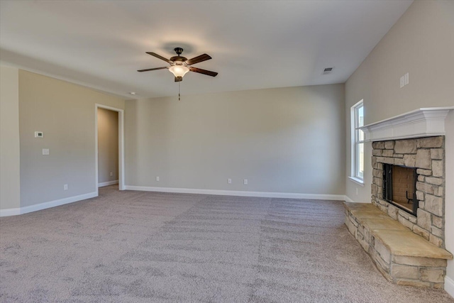 unfurnished living room featuring a fireplace, light colored carpet, and ceiling fan