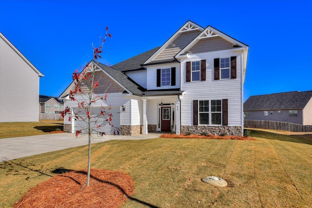 craftsman house featuring a front yard and a garage