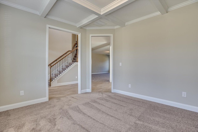 unfurnished room featuring beam ceiling, light colored carpet, crown molding, and coffered ceiling