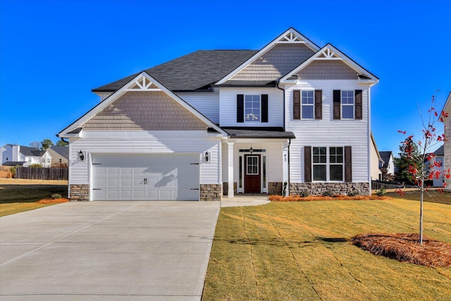 craftsman-style house with a garage and a front lawn