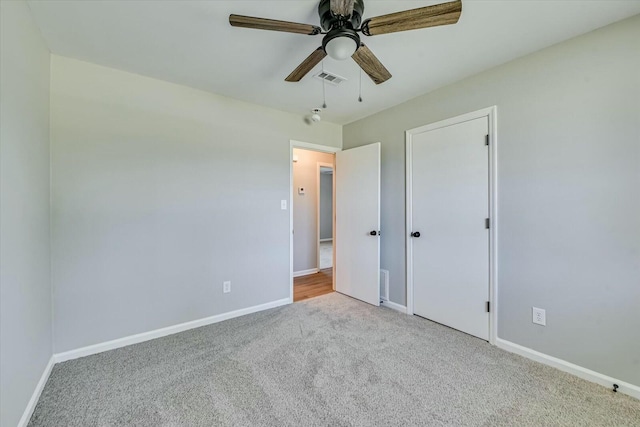 unfurnished bedroom featuring carpet floors, visible vents, ceiling fan, and baseboards