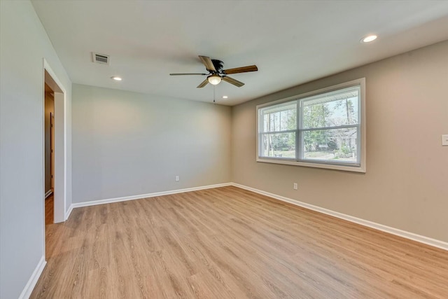 unfurnished room with recessed lighting, visible vents, ceiling fan, light wood-type flooring, and baseboards