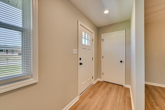 entryway featuring light wood-type flooring and baseboards