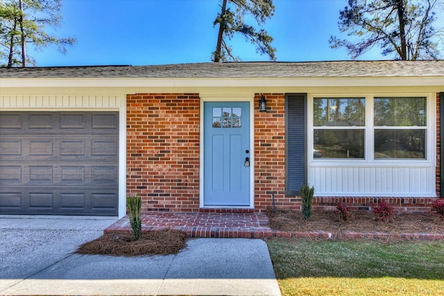 view of front of house featuring a garage and brick siding