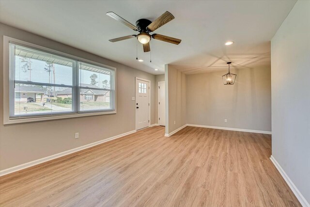 unfurnished room featuring light wood finished floors, baseboards, and recessed lighting