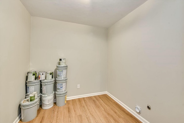 empty room featuring light wood finished floors and baseboards