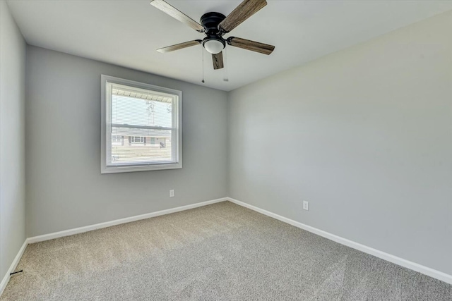 unfurnished room featuring carpet, ceiling fan, and baseboards