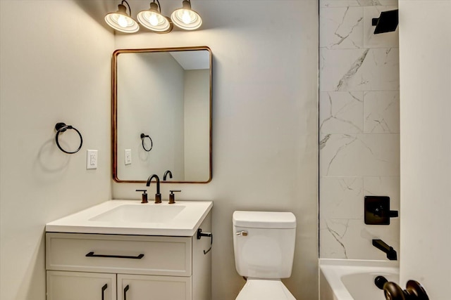 bathroom featuring toilet, shower / bathing tub combination, and vanity