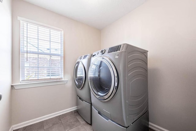 washroom featuring separate washer and dryer and light tile patterned flooring