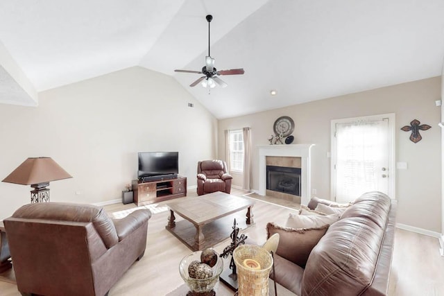 living room with ceiling fan, light hardwood / wood-style floors, and lofted ceiling