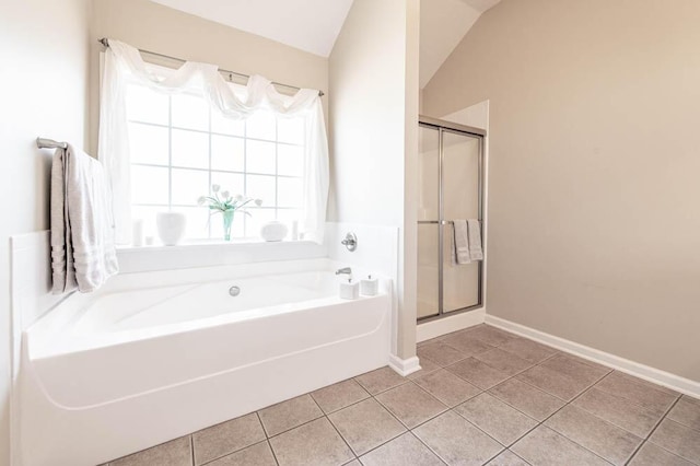 bathroom with tile patterned flooring, independent shower and bath, and vaulted ceiling