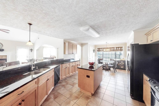 kitchen featuring pendant lighting, a center island, sink, and black dishwasher