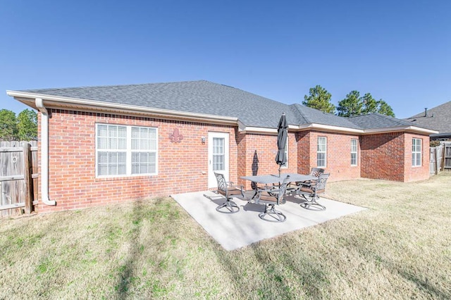 back of property featuring a yard and a patio area