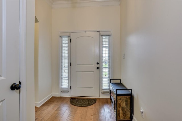 entryway featuring hardwood / wood-style flooring, plenty of natural light, and crown molding